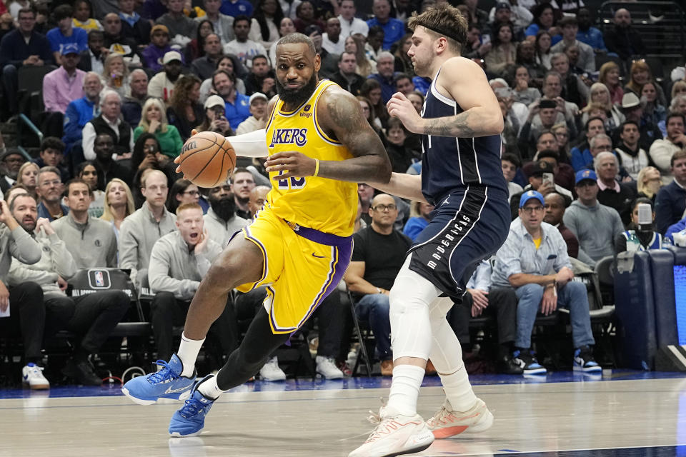Los Angeles Lakers forward LeBron James (23) drives against Dallas Mavericks guard Luka Doncic during the second half of an NBA basketball game in Dallas, Tuesday, Dec. 12, 2023. (AP Photo/LM Otero)