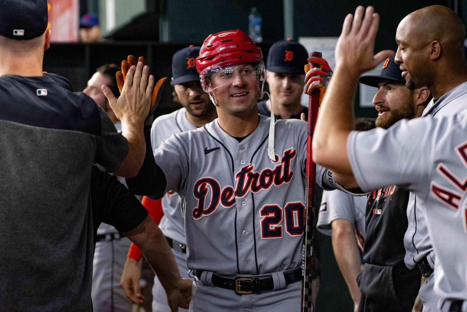 Detroit Tigers' Spencer Torkelson (20) high-fives teammates in the dugout after hitting a solo home run in the top of the fifth inning of a baseball game against the Texas Rangers in Arlington, Texas, Thursday, June 29, 2023. (AP Photo/Emil T. Lippe)