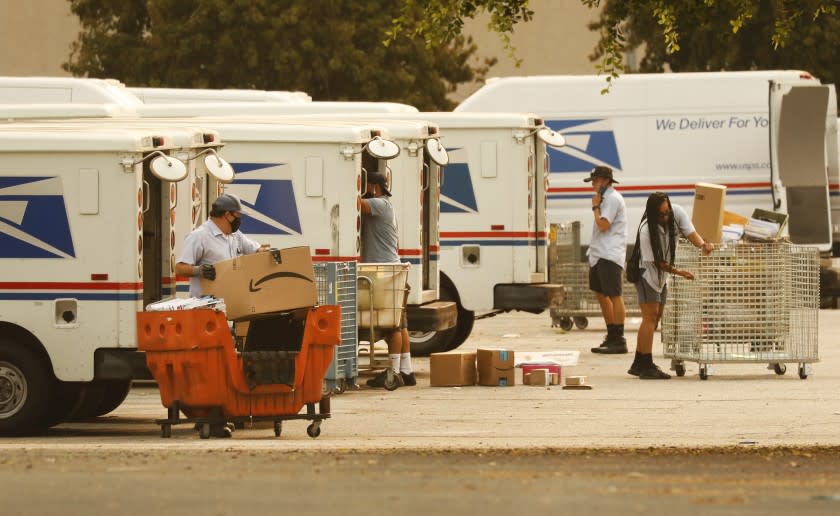 VAN NUYS, CA - SEPTEMBER 09: Mail carriers load their trucks at the United States Postal Service (USPS) located at 15701 Sherman Way in Van Nuys, California on the morning of September 9, 2020. The USPS may be experiencing delays. U.S. Postal Service on Wednesday, Sept. 9, 2020 in Van Nuys, CA. (Al Seib / Los Angeles Times