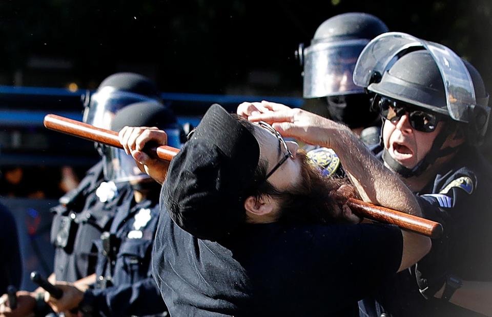 A protester is hit with a baton by a police officer on May 29, 2020, in San Jose, California, during protests over the death of George Floyd.