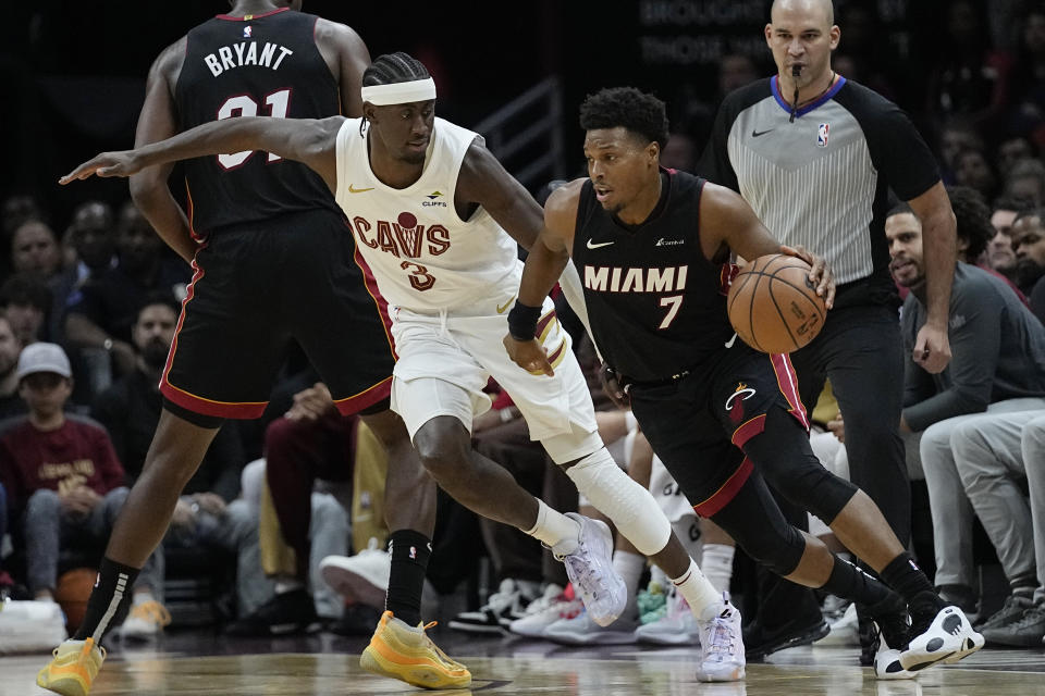 Miami Heat guard Kyle Lowry (7) drives around Cleveland Cavaliers guard Caris LeVert (3) during the second half of an NBA basketball game Wednesday, Nov. 22, 2023, in Cleveland. (AP Photo/Sue Ogrocki)