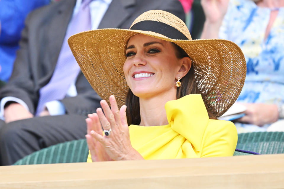 At one point, while watching the game, she kept cool in a straw hat. (Getty Images)