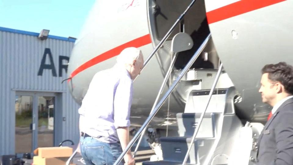 WikiLeaks founder Julian Assange boards a plane at a location given as London, Britain, in this still image from video released June 25 2024 (via REUTERS)