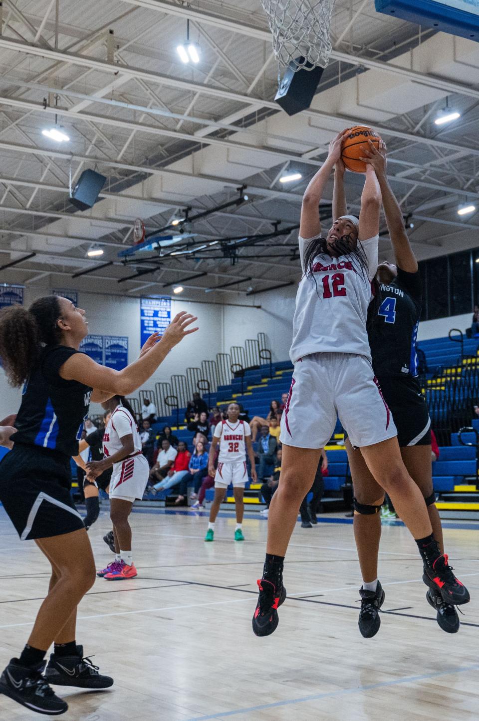 Palm Beach Central center Tamia Coleman (12) and Wellington forward Gianna Miclis (24) battle for a rebound during the District 8-7A girls basketball championship game between host Wellington and Palm Beach Central on Friday, February 3, 2023, in Wellington, FL. Final score, Palm Beach Central, 51, Wellington, 41.