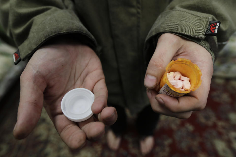 In this Nov. 14, 2019 photo, Jon Combes holds his bottle of buprenorphine, a medicine that prevents withdrawal sickness in people trying to stop using opiates, as he prepares to take a dose in a clinic in Olympia, Wash. The clinic is working to spread a philosophy called "medication first," which scraps requirements for counseling, abstinence or even a commitment to recovery in the battle against addictions to heroin and other opioids. (AP Photo/Ted S. Warren)