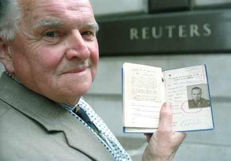 FILE PHOTO: Doon Campbell poses holding his war correspondent license outside of the Reuters office in London