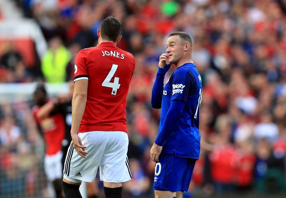 Everton’s Wayne Rooney (right) and Manchester United’s Phil Jones have a catch-up during the game