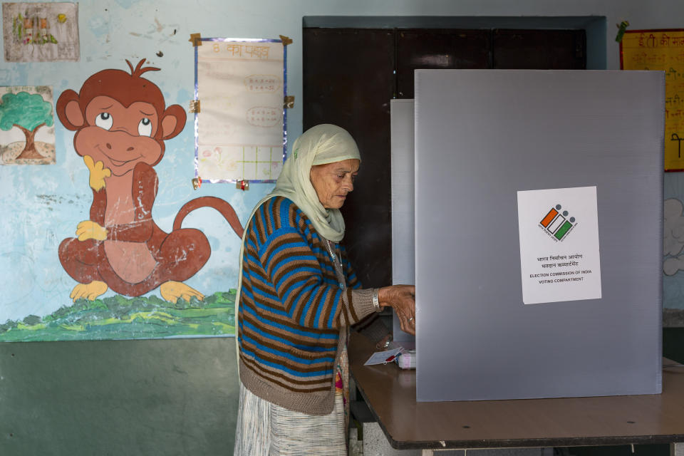 A voter casts her ballot in a bypoll for an assembly seat in Dharmsala, India, Monday, Oct. 21, 2019. The seat was vacated by Kishan Kapoor, a Bharatiya Janata Party member of legislative assembly , who was elected to the Lok Sabha in May as Voting is underway in two Indian states of Maharashtra in the west and Haryana in the north where the Hindu nationalist Bharatiya Janata Party (BJP) headed by prime minister Narendra Modi is trying to win a second consecutive term. (AP Photo/Ashwini Bhatia)