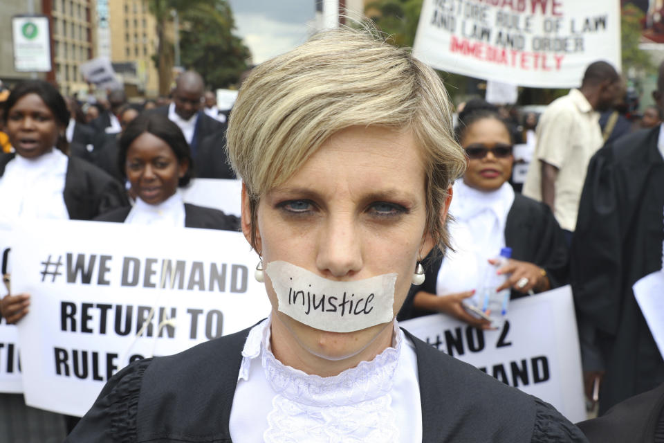 Zimbabwe lawyers take part in a protest over rule of law concerns in Harare, Tuesday Jan. 29, 2018. The lawyers handed over a petition to the country's Chief Justice in a bid to stop human rights abuses in the country. Zimbabwe's president Monday said he was "appalled" by a televised report showing abuses by security forces in a continuing crackdown after angry protests against the government's drastic fuel price hikes. (AP Photo/Tsvangirayi Mukwazhi)