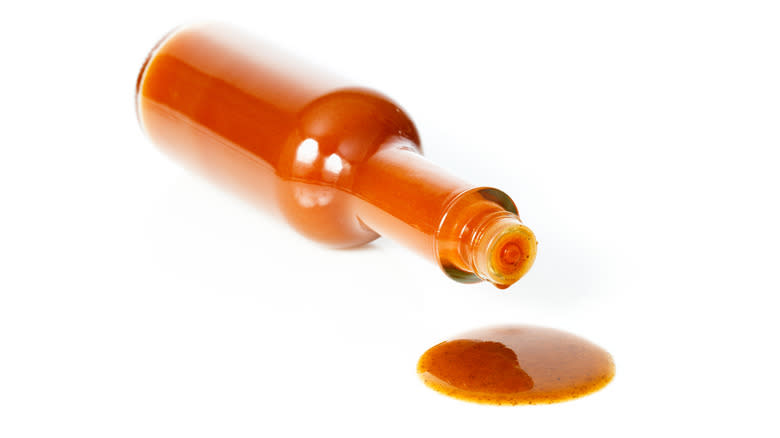 Bottle of hot sauce pouring out