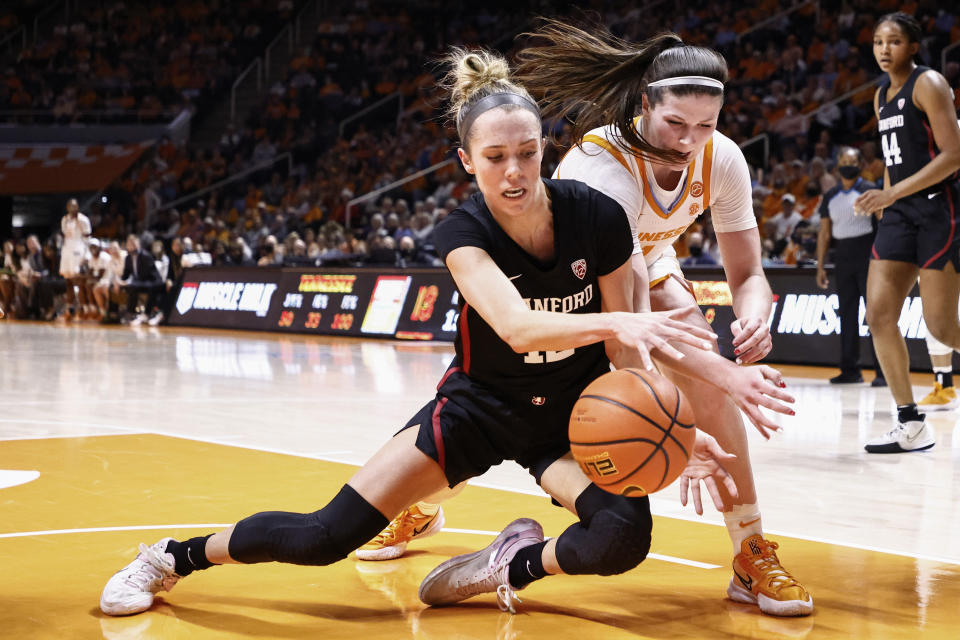 Stanford guard Lexie Hull, left, battles for the ball with Tennessee guard Sara Puckett, front right, during the first half of an NCAA college basketball game Saturday, Dec. 18, 2021, in Knoxville, TN. (AP Photo/Wade Payne)