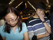 People, who said they believed their relatives were on Malaysia Airlines flight MH17, react as they wait for more information about the crashed plane at Kuala Lumpur International Airport in Sepang July 18, 2014. The Malaysia Airlines Boeing 777 was brought down over eastern Ukraine on Thursday, killing all 295 people aboard and sharply raising the stakes in a conflict between Kiev and pro-Moscow rebels in which Russia and the West back opposing sides. REUTERS/Olivia Harris (MALAYSIA - Tags: TRANSPORT DISASTER POLITICS)