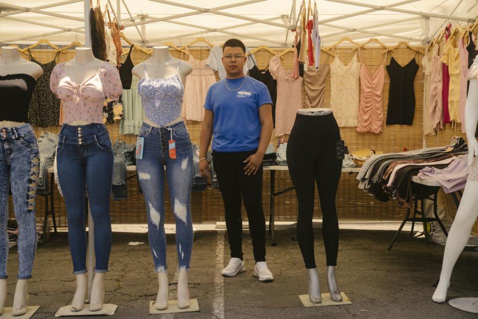 Victor Galindo, a vendor organizer, in his clothing stand at the temporary market in the neighboring church parking lot.