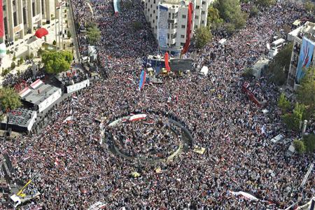 A photo taken from a helicopter shows supporters of Syrian President Bashar al-Assad's gathering during a rally at al-Sabaa Bahrat square in Damascus October 12, 2011. REUTERS/Wael Hmidan