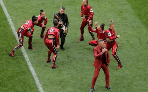 Robbie Williams performs during the opening ceremony - Credit: Reuters