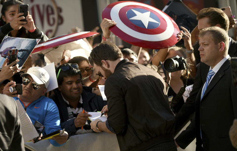 Chris Evans signs autograph as he attends the premiere for "Knives Out" on day three of the Toronto International Film Festival at the Princess of Wales Theatre on Saturday, Sept. 7, 2019, in Toronto. (Photo by Evan Agostini/Invision/AP)