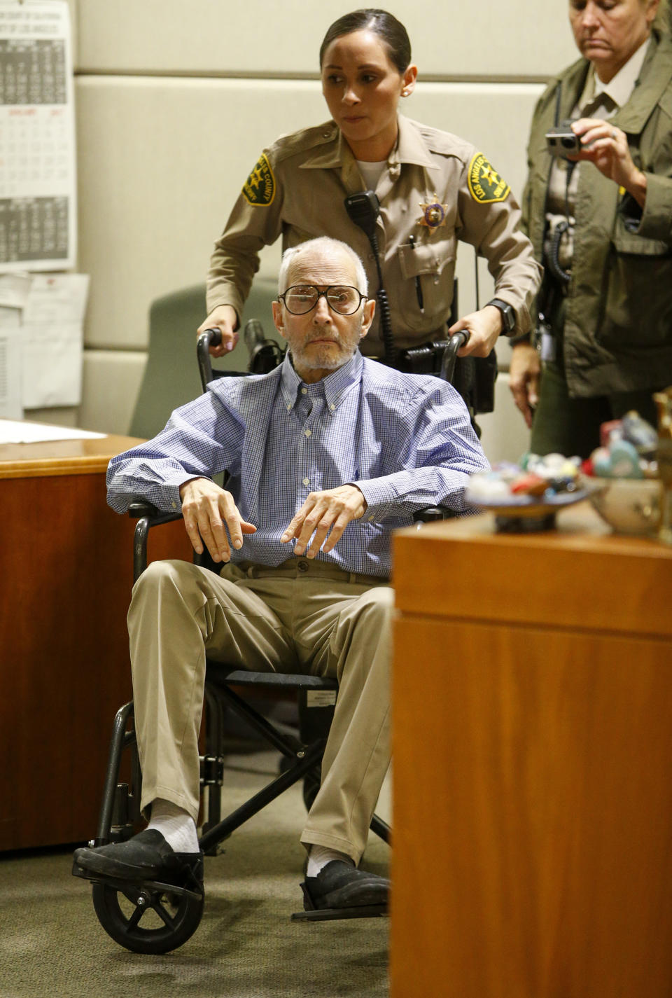 FILE - In this Jan.6, 2017 file photo real estate heir Robert Durst is wheeled into a courtroom in a Los Angeles Superior Court Airport Branch in Los Angeles. Durst faces trial in the slaying of his best friend 20 years ago. Jury selection begins Wednesday, Jan.19, 2020, in Los Angeles. (Mark Boster/Los Angeles Times via AP, Pool,File)