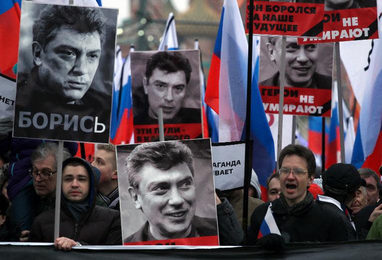Russia's opposition supporters carry portraits of Kremlin critic Boris Nemtsov during a march in central Moscow on March 1, 2015