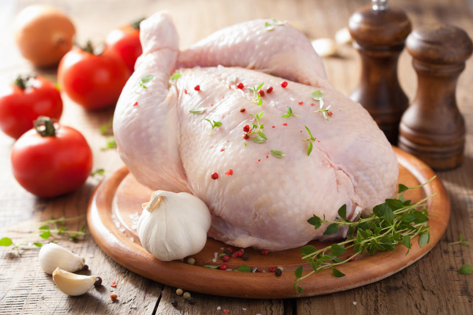 whole raw chicken with rose pepper and thyme