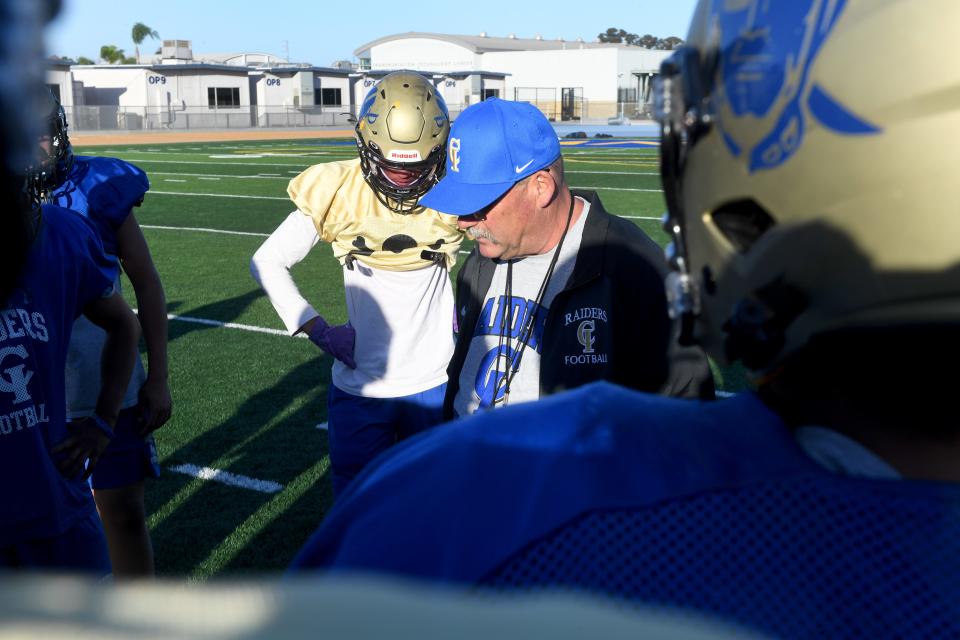 Head coach Gary Porter goes over plays with his Channel Islands High football team during a practice on Oct. 24.