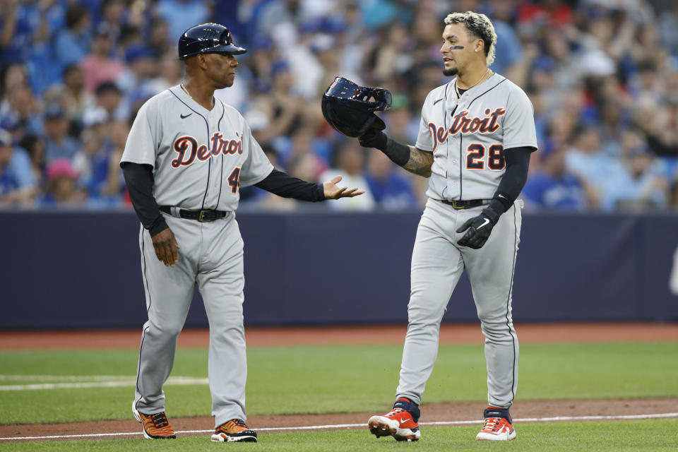 Detroit Tigers shortstop Javier Baez (28) hands his batting helmet to third base coach Gary Jones (44) after being called out on a double play in second-inning baseball game action against the Toronto Blue Jays in Toronto, Thursday, April 13, 2023. (Cole Burston/The Canadian Press via AP)