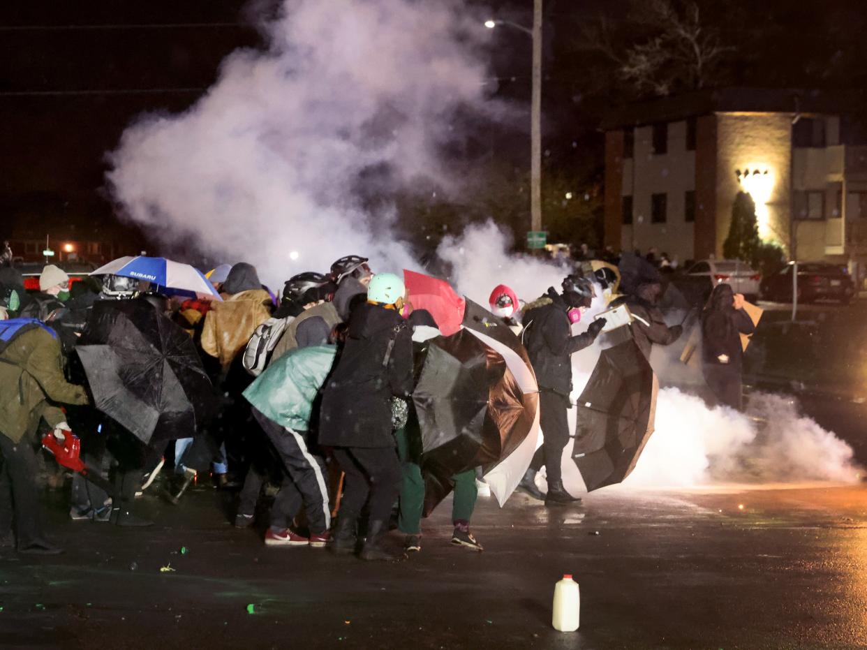 Demonstrators protesting the shooting death of Daunte Wright face off with police near the Brooklyn Center police station on 13 April, 2021 (Getty Images)