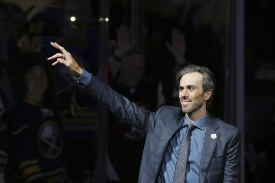 Former Buffalo Sabres goaltender Ryan Miller waves to the crowd as he's introduced before the team's NHL hockey game against the New York Islanders on Thursday, Jan. 19, 2023, in Buffalo, N.Y. (AP Photo/Joshua Bessex)