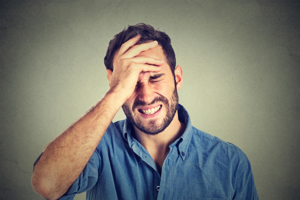 Man holding his head and closing his eyes