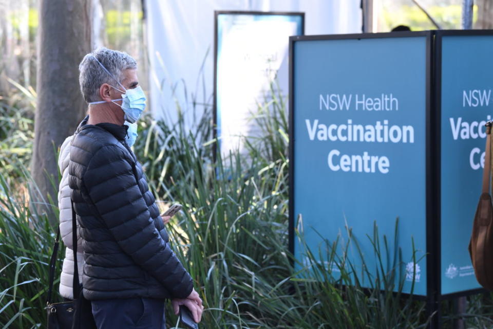 People queue to receive the COVID-19 vaccine at the New South Health Vaccination Centre at Sydney Olympic Park in Sydney, Australia. 