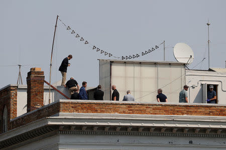 People are seen on the rooftop at the Consulate General of Russia in San Francisco, California, U.S., September 2, 2017. REUTERS/Stephen Lam