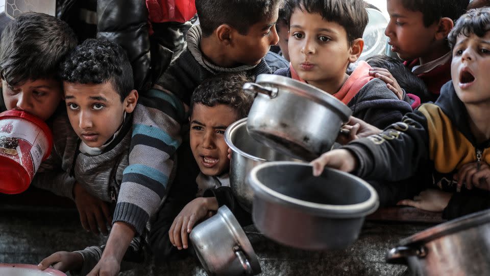 Children await food being handed out by aid organizations in Rafah. - Belal Khaled/Anadolu/Getty Images