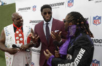 Vince Wilfork, left and DeAngelo Williams, right, speaks with Florida State defensive end Brian Burns on the red carpet ahead of the first round at the NFL football draft, Thursday, April 25, 2019, in Nashville, Tenn. (AP Photo/Steve Helber)