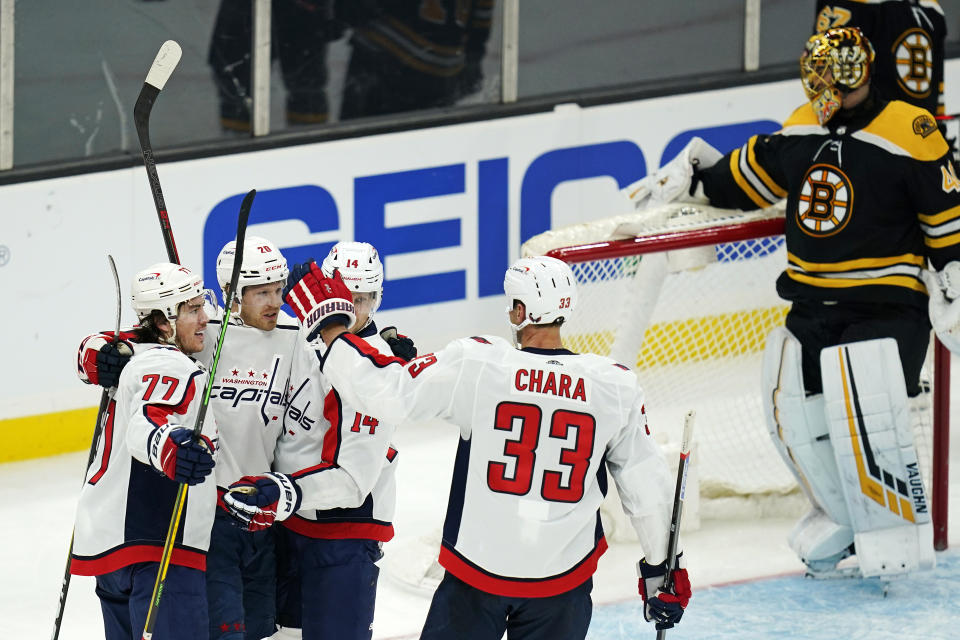 Washington Capitals center Lars Eller (20) is congratulated by teammates after his goal against Boston Bruins goaltender Tuukka Rask, rear right, during the third period of an NHL hockey game, Wednesday, March 3, 2021, in Boston. From left are Capitals Washington Capitals T.J. Oshie (77), Ellers, Richard Panik (14) and Zdeno Chara (33). (AP Photo/Charles Krupa)