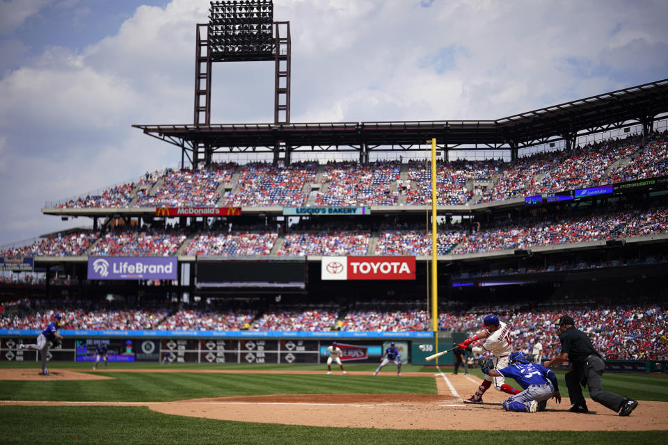 Philadelphia Phillies' Kyle Schwarber hits a two-run home run against Kansas City Royals pitcher Zack Greinke during the second inning of a baseball game, Sunday, Aug. 6, 2023, in Philadelphia. (AP Photo/Matt Slocum)