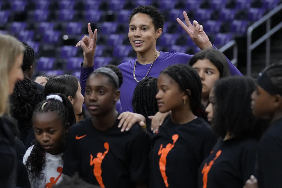 Phoenix Mercury center Brittney Griner (42) joins a group of girls for a photo on the court before a WNBA basketball game against the Los Angeles Sparks in Los Angeles, Friday, May 19, 2023. (AP Photo/Ashley Landis)