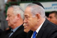 Israeli Prime Minister Benjamin Netanyahu looks on as he sits next to Benny Gantz, leader of Blue and White party, during a memorial ceremony for late Israeli President Shimon Peres, at Mount Herzl in Jerusalem