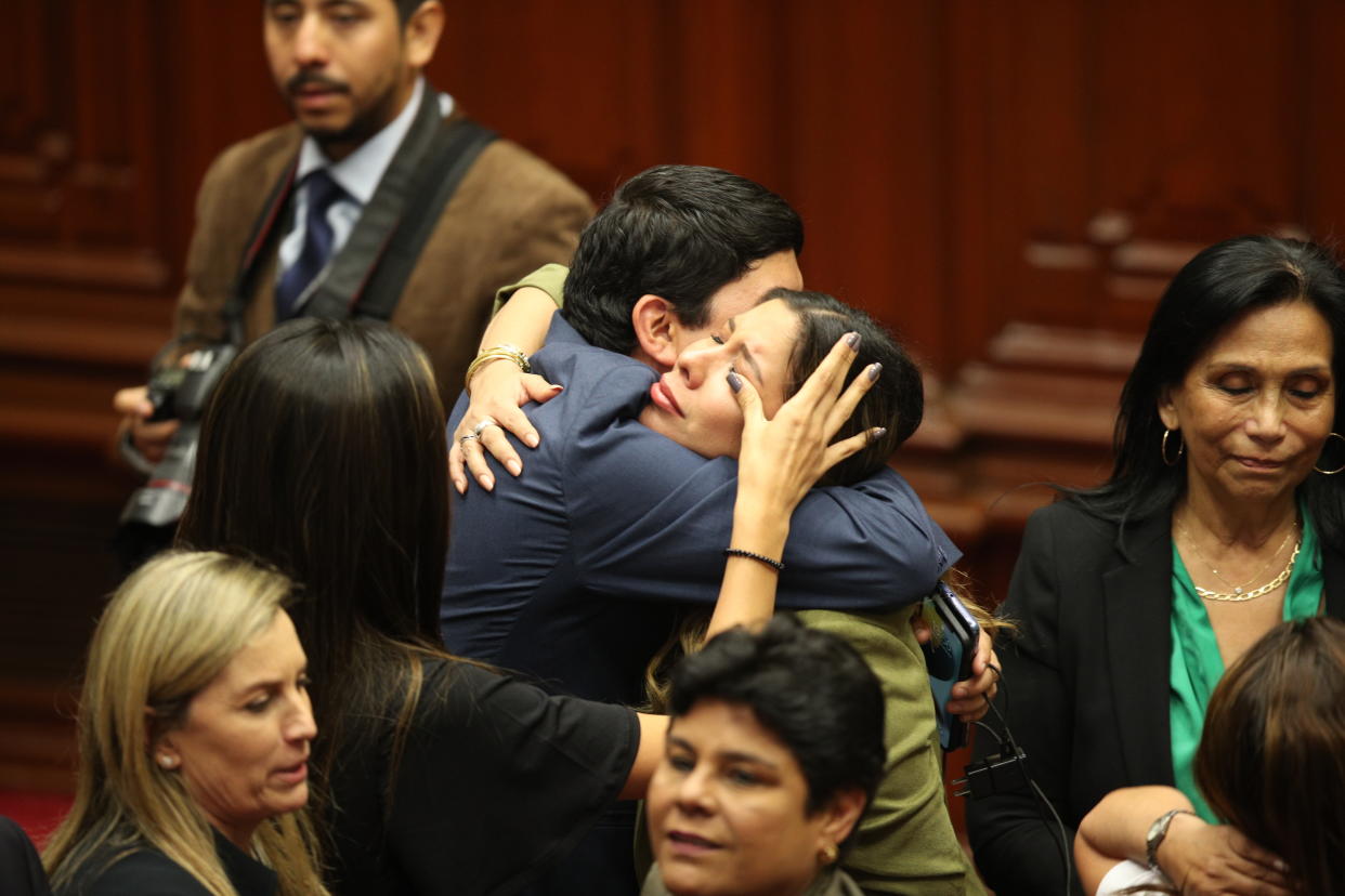 Lawmakers celebrate after verbally voting to remove President Pedro Castillo from office in Lima, Peru, Wednesday, Dec. 7, 2022. Peru's Congress voted to remove Castillo from office Wednesday and replace him with the vice president, shortly after Castillo tried to dissolve the legislature ahead of a scheduled vote to remove him.(AP Photo/Guadalupe Pardo)