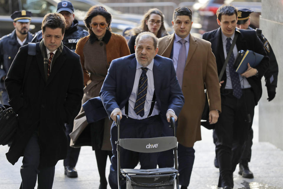 Harvey Weinstein, center, arrives at a Manhattan courthouse for his rape trial in New York, Friday, Feb. 14, 2020. (AP Photo/Seth Wenig)