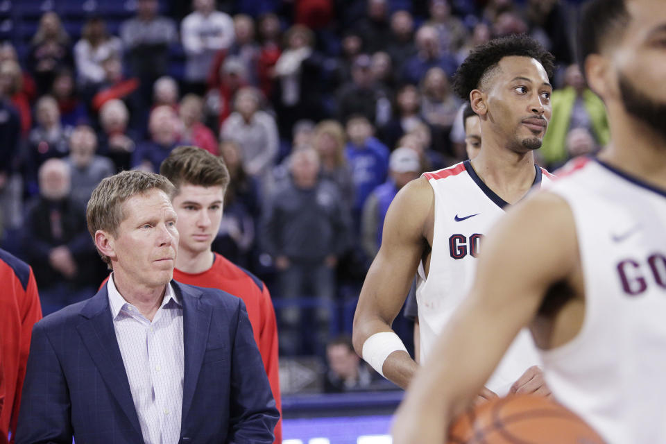 Gonzaga head coach Mark Few, left, and forward Johnathan Williams look on during senior day activities after an NCAA college basketball game against Pepperdine in Spokane, Wash., Saturday, Feb. 17, 2018. (AP Photo/Young Kwak)