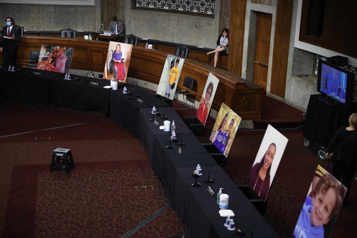 Images of people who’ve been helped by the Affordable Care Act occupy the seats of Democratic senators boycotting a Senate Judiciary Committee meeting on the nomination of Judge Amy Coney Barrett to be an associate justice of the US Supreme Court on 22 October. (EPA)