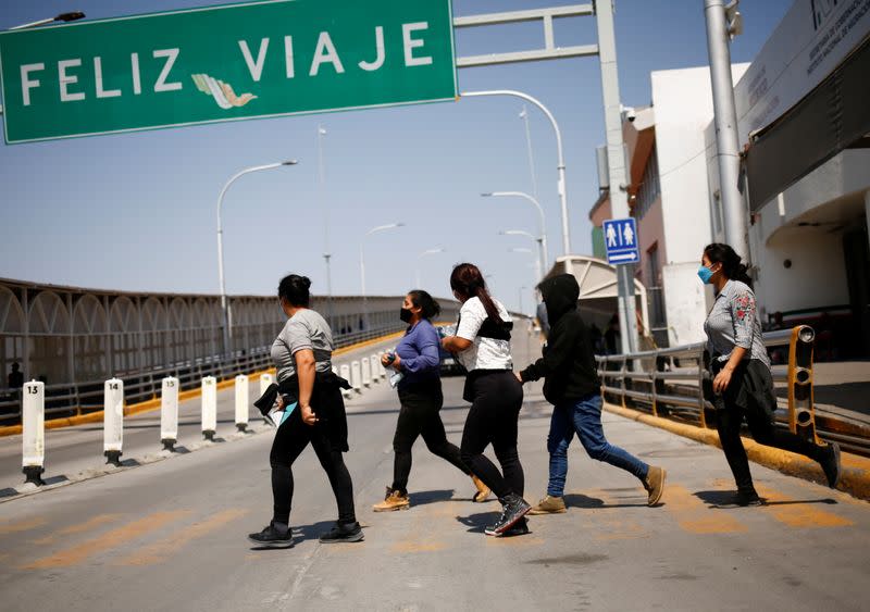 Migrants expelled from the U.S. and sent back to Mexico under Title 42 walk towards Mexico at the Paso del Norte International border bridge, in Ciudad Juarez