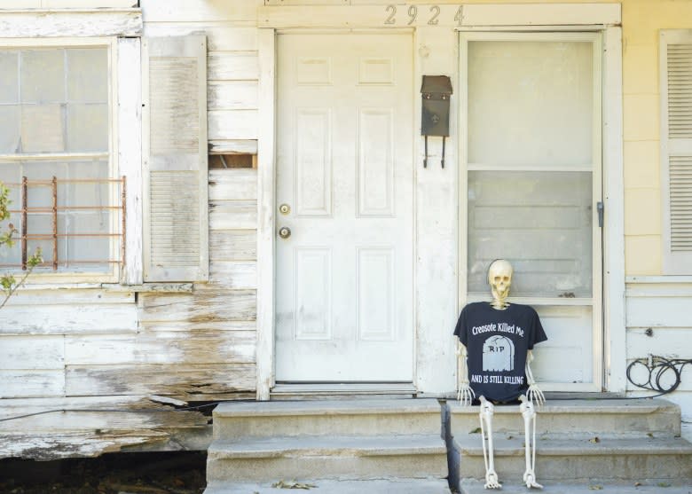 “Creosote man” is the nickname for this plastic skeleton that accompanies local activists to hearings and protests. His T-shirt reads, “Creosote killed me and is still killing.” (Jason Fochtman/Houston Chronicle via Getty Images)