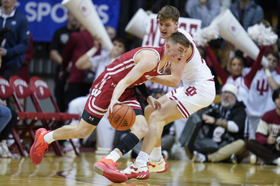 Wisconsin's Connor Essegian (3) goes to the basket against Indiana's Miller Kopp (12) during the second half of an NCAA college basketball game, Saturday, Jan. 14, 2023, in Bloomington, Ind. (AP Photo/Darron Cummings)