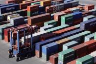 Container transport vehicles move at the HHLA container terminal Burchardkai at Hamburg harbour in this May 5, 2010 file picture. In recent weeks, the economy that proud German politicians have taken to describing as a "growth locomotive" and "stability anchor" for Europe, has been hit by a barrage of bad news that has surprised even the most ardent Germany sceptics. The big shocker came on August 14, 2014, when the Federal Statistics Office revealed that gross domestic product (GDP) had contracted by 0.2 percent in the second quarter. Picture taken May 5, 2010. TO MATCH STORY GERMANY-ECONOMY/ REUTERS/Christian Charisius/Files (GERMANY - Tags: TRANSPORT BUSINESS)