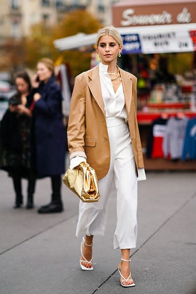 Woman-wears-camel-blazer-and-white-trousers