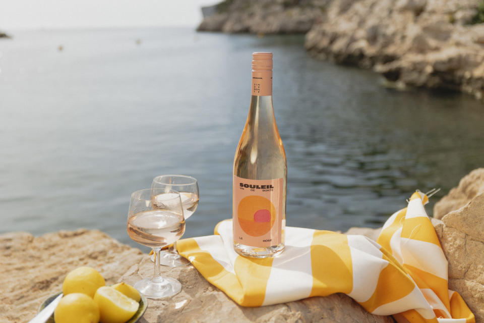 <p>Courtesy of Souleil Vin de Bonté</p><sub><em>SOULEIL = “SUN” IN ANCIENT FRENCH</em></sub><p><strong><em>BONTÉ = “GOODNESS”</em></strong></p><p>Souleil’s story starts in a sun-drenched wine region of southern France along the Mediterranean Sea, where founders Marianne and Thomas grew up surfing and shucking oysters. After years cultivating their own expertise working in wine, the childhood friends began to dream about making a wine that embodies the feel of an endless summer.</p><p>Focusing on sustainability, they created Souleil Vin de Bonté, a vegan and organic wine intended to be served with a side of purpose. Part of Souleil Vin de Bonté’s proceeds go toward protecting one of the planet’s most valuable resources: our oceans.</p><p><a href="https://souleilwines.com/shoppage" rel="nofollow noopener" target="_blank" data-ylk="slk:Click here to purchase;elm:context_link;itc:0;sec:content-canvas" class="link ">Click here to purchase</a></p>