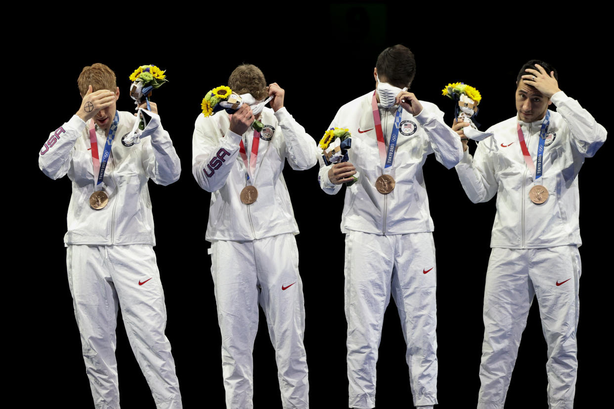 Race Imboden (far left) offers a silent protest during the medal ceremony. (Molly Darlington/Reuters)