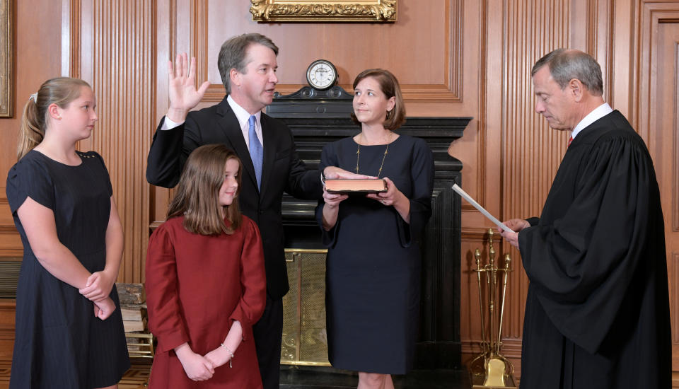 Judge Brett Kavanaugh is sworn in as an associate justice of the U.S. Supreme Court by Chief Justice John Roberts with his wife, Ashley, holding the family bible and his daughters, Liza and Margaret, at the Supreme Court building on Oct. 6. (Photo: Fred Schilling/Collection of the Supreme Court of the United States/Handout via Reuters )