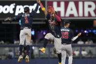Atlanta Braves second baseman Ozzie Albies (1) and right fielder Ronald Acuna Jr. celebrate after defeating the Miami Marlins at the end of a baseball game, Tuesday, May 2, 2023, in Miami. The Braves defeated the Marlins 6-0. (AP Photo/Marta Lavandier)