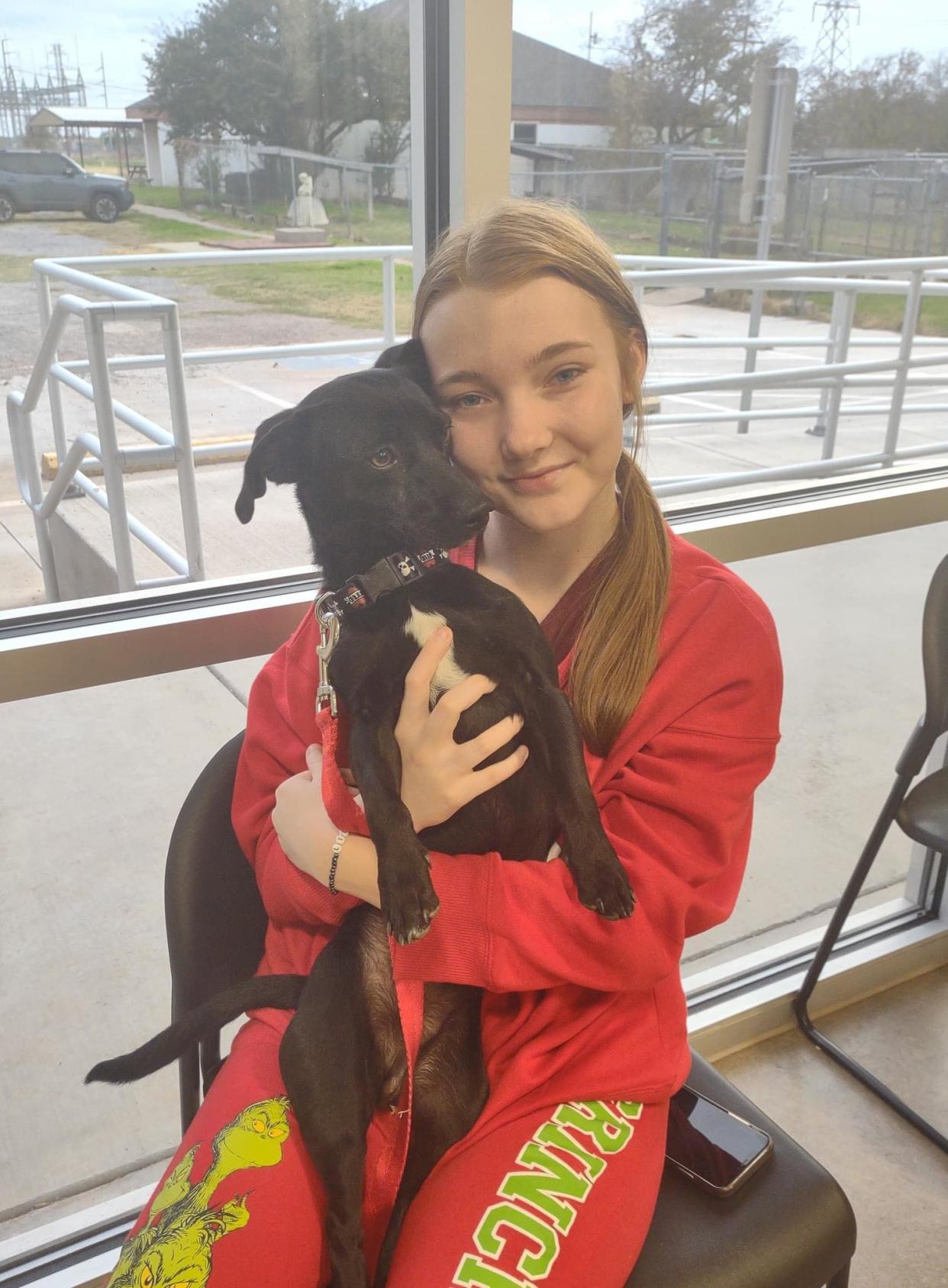 Taryn Brooks with Eddie the dachshund mix. She gave up some of her Christmas gifts to adopt Eddie after seeing a post about him online.